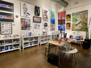  Interior of Tucson Gallery showcasing local art, including murals by Ignacio Garcia, with a selection of unique souvenirs and gifts.